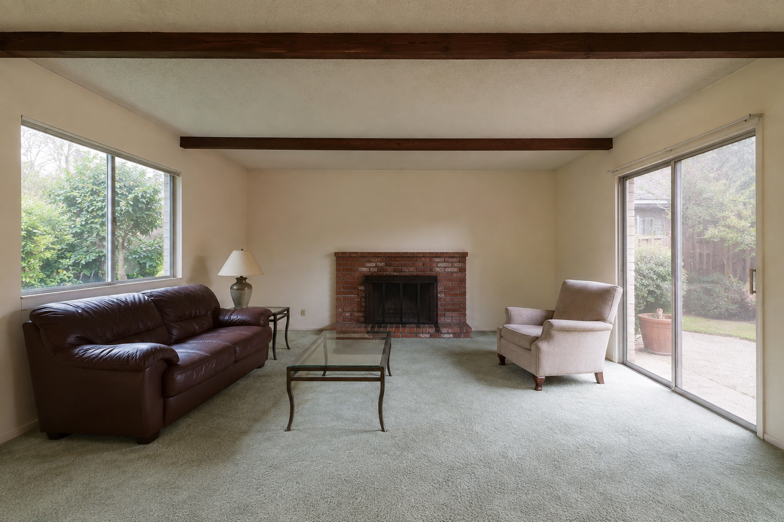 Living room with original carpet and brick fireplace